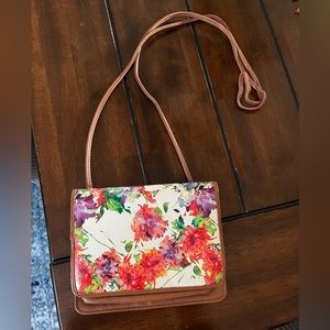 Floral patterned cross body purse.